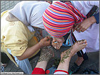 Applying henna